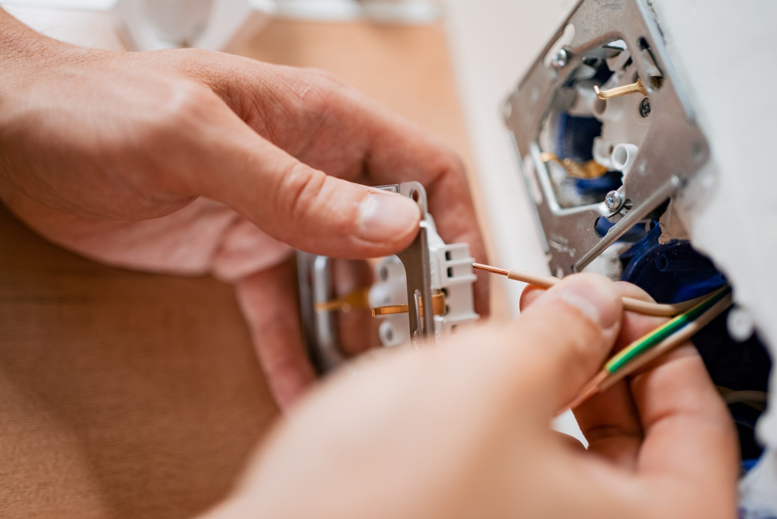Close-up,Of,An,Electrician's,Hands,Carefully,Connecting,Wires,To,A